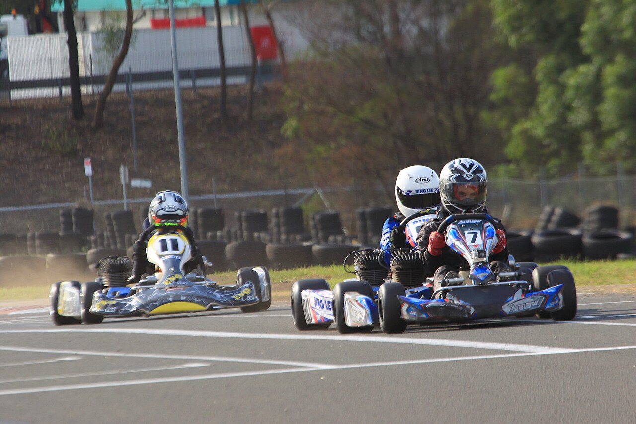 Go-kart drivers racing around an outdoor circuit